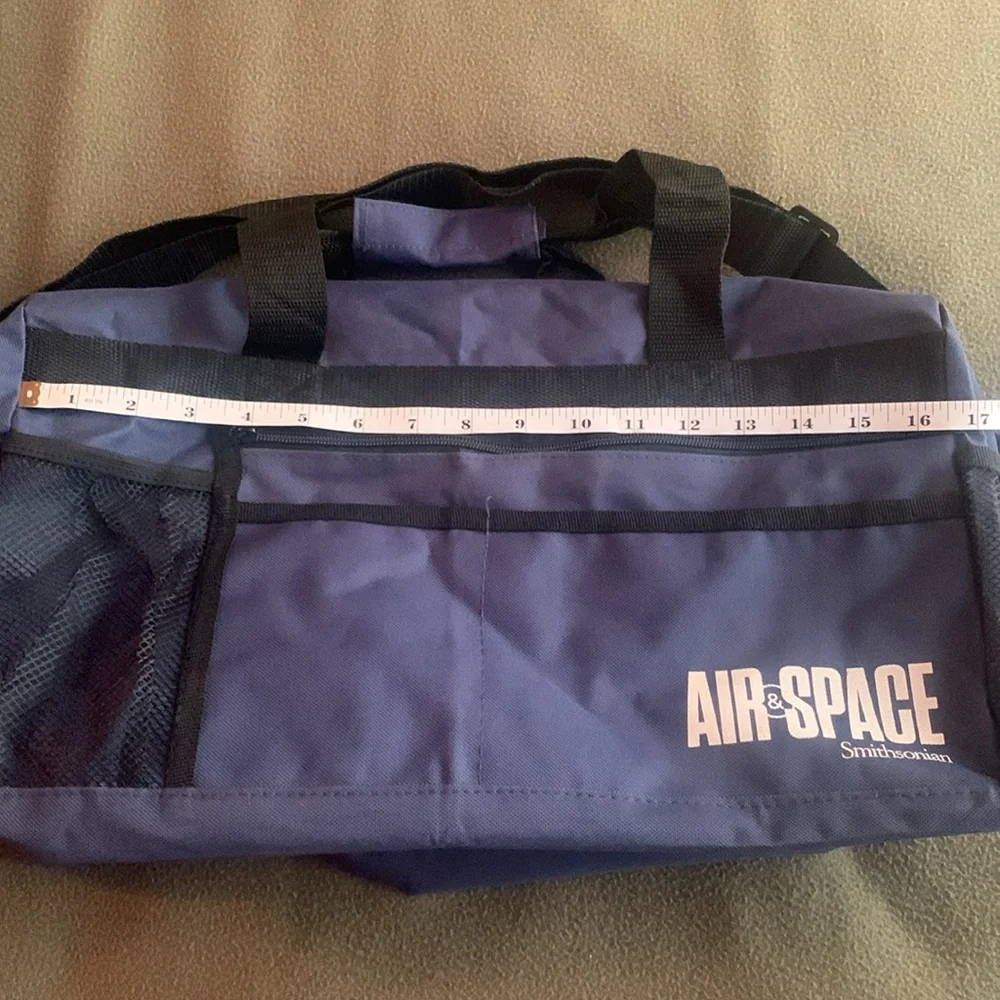 Smithsonian Air & Space blue and black duffel bag. Approx 17” x 9” x 7 1/4”